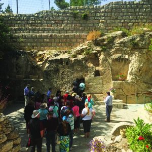 Group of HBU Students and Staff walking into a small cave in Israel.